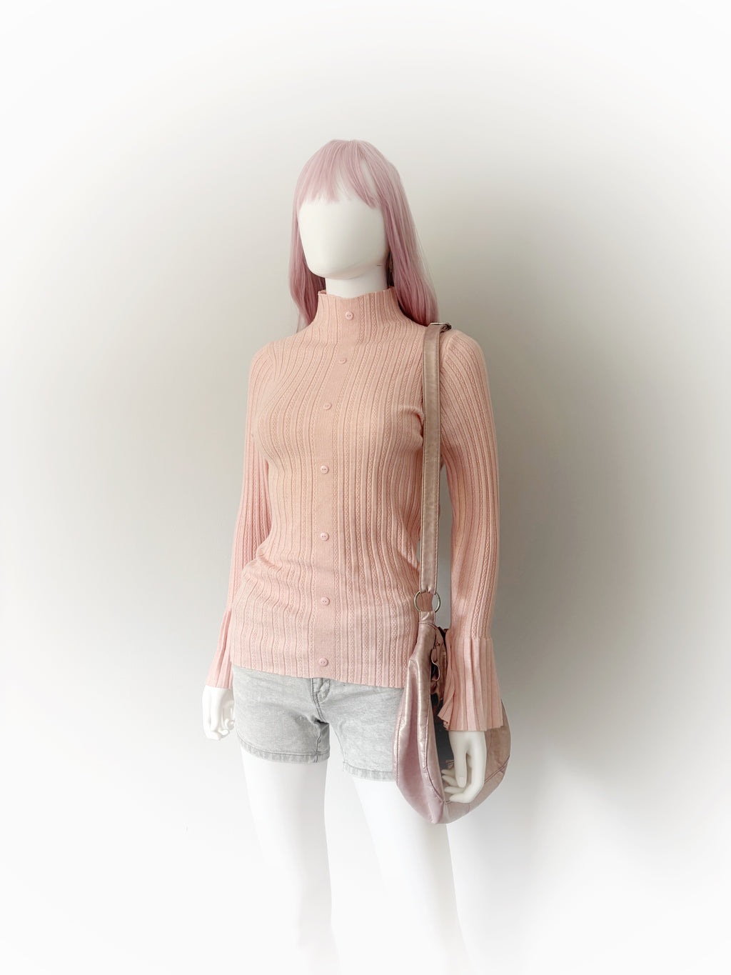 Pink ribbed turtleneck sweater with flared sleeves